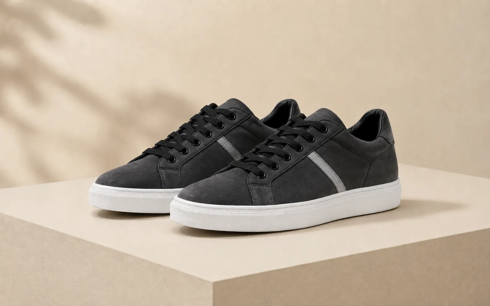 Before-and-after comparison of white sneakers edited into a darker suede style with new detailing. overlay