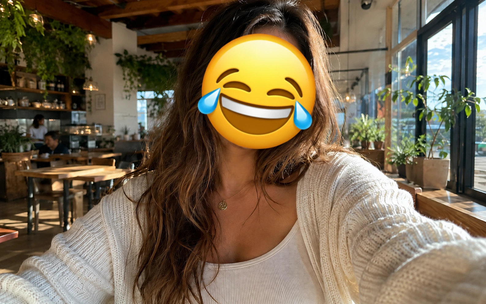 Before-and-after comparison of a cafe selfie with the face covered by a laughing emoji. result