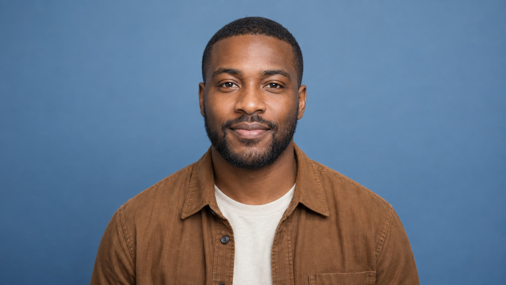 Man with a beard in a brown overshirt