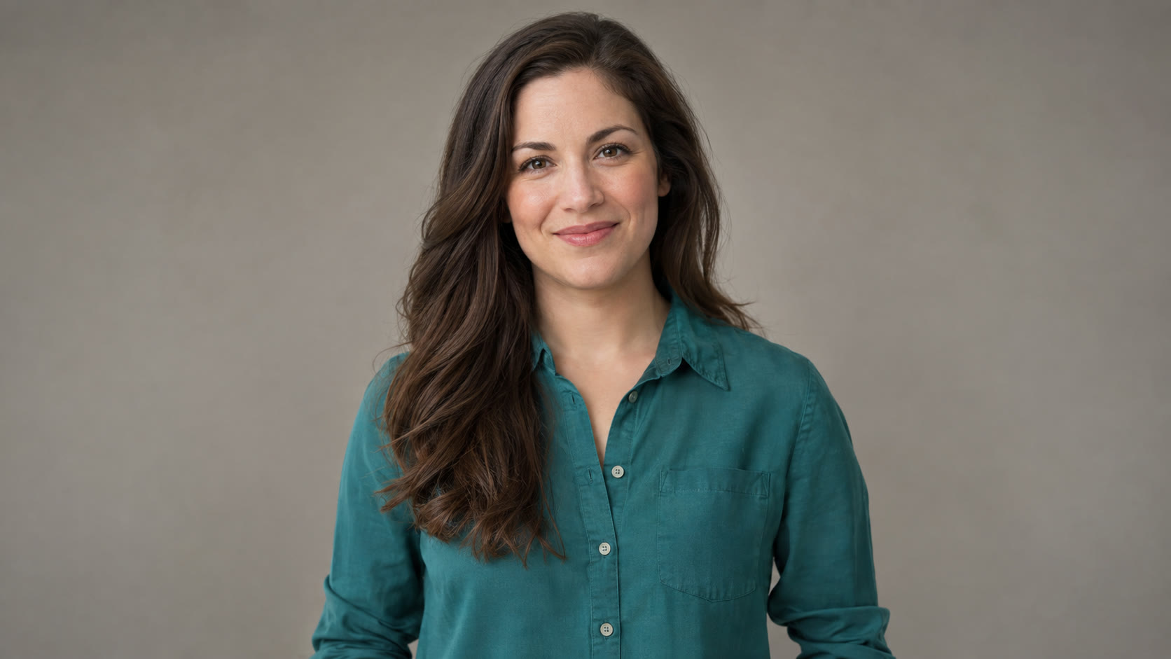 Woman with dark hair in a teal shirt